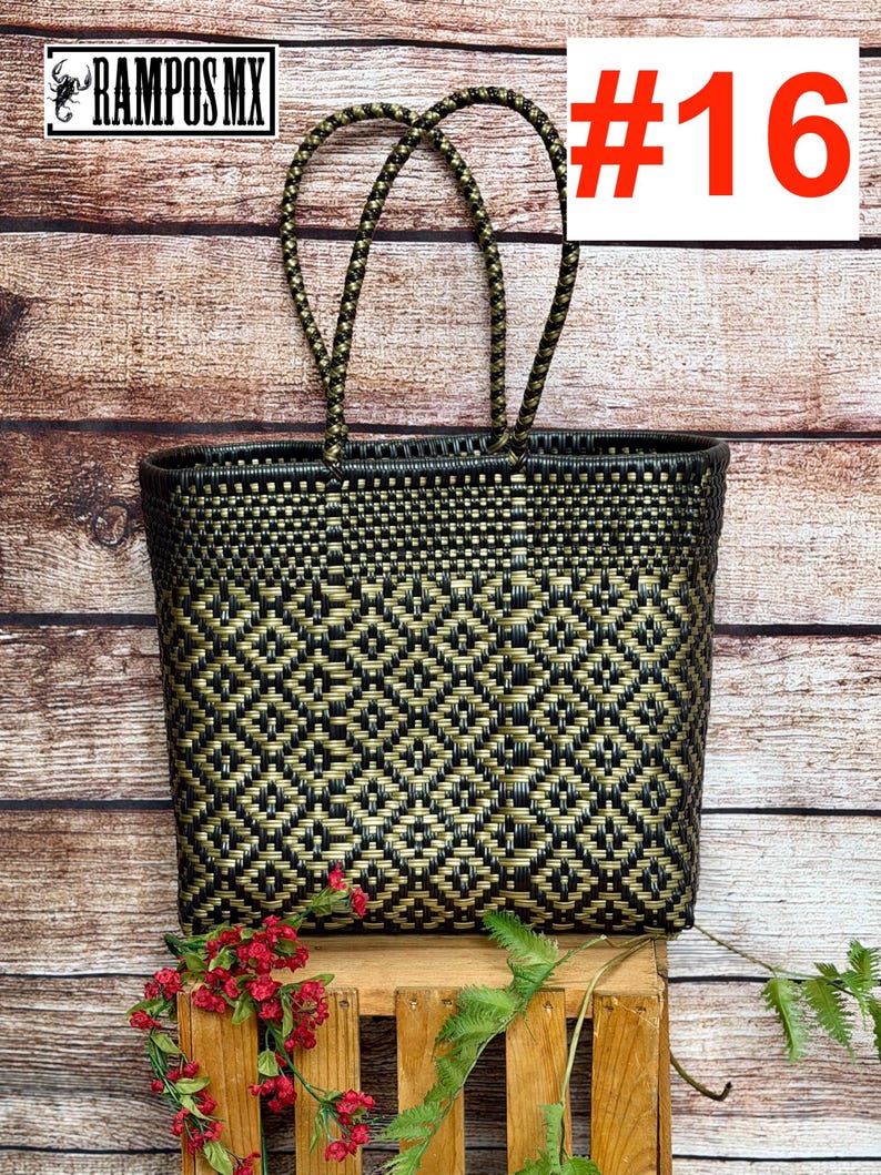 May include: A black and gold woven tote bag featuring a geometric diamond pattern, two braided handles, and the text RAMPOS MX and #16. The bag is constructed from thin plastic strips woven in a tight, repeating grid design with a rectangular shape.