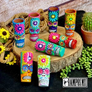 May include: A set of three ceramic mugs with a speckled, matte finish. The mugs are in shades of cream, light gray, and dark gray. Each mug has a simple, minimalist design, perfect for coffee or tea.