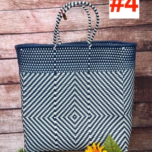 May include: A large, woven tote bag with a geometric diamond pattern in navy blue and white. The bag has sturdy handles and a navy blue trim. The text "#4" is in a red box. The bag is displayed on a wooden surface with a sunflower.