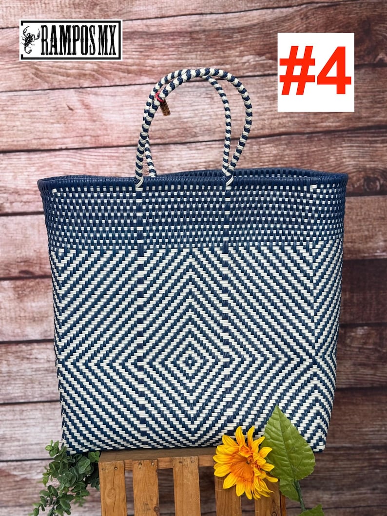 May include: A large, woven tote bag with a geometric diamond pattern in navy blue and white. The bag has sturdy handles and a navy blue trim. The text "#4" is in a red box. The bag is displayed on a wooden surface with a sunflower.