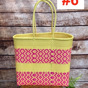 May include: A woven tote bag in yellow and pink. The bag features a geometric pattern in pink and yellow, with a rectangular shape and two handles. The number "#6" is displayed in red on a white background. The brand name "RAMPOS MX" is visible.