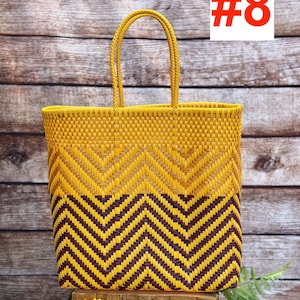 May include: A woven tote bag with a yellow and brown chevron pattern. The bag has two handles and a rectangular shape. The text "#8" is in a white box in the upper right corner. The brand name "RAMPOS MX" is in the upper left corner.