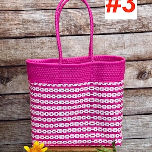 May include: A vibrant pink and white woven tote bag with a rectangular shape and two handles. The bag features a repeating pattern of white rectangles against a pink background. The number "#3" is displayed in a white box with a red border. The brand name "RAMPOS MX" is visible.