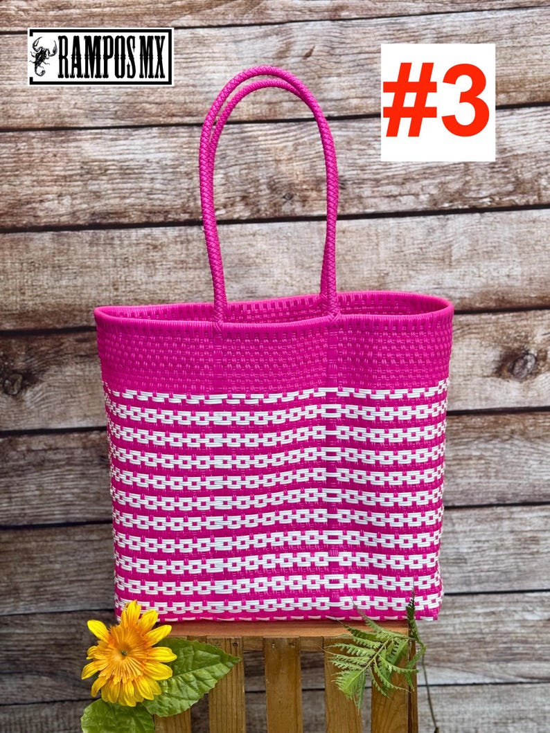 May include: A vibrant pink and white woven tote bag with a rectangular shape and two handles. The bag features a repeating pattern of white rectangles against a pink background. The number "#3" is displayed in a white box with a red border. The brand name "RAMPOS MX" is visible.