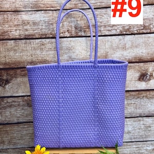 May include: A woven, lavender tote bag with two handles. The bag is rectangular and has a textured pattern. The image includes the text "#9" in a red box and the logo "RAMPOS MX" in a black box.