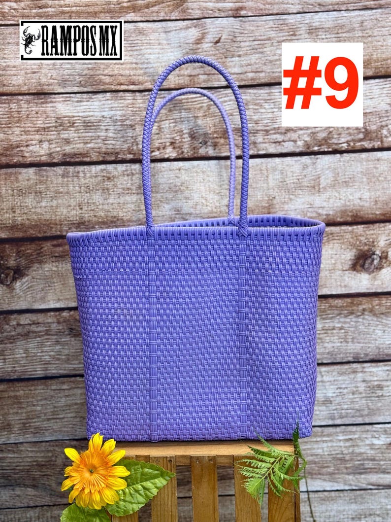 May include: A woven, lavender tote bag with two handles. The bag is rectangular and has a textured pattern. The image includes the text "#9" in a red box and the logo "RAMPOS MX" in a black box.
