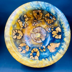 Turned bowl of cholla cactus with blue and gold resin with a pine base.