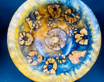 Turned bowl of cholla cactus with blue and gold resin with a pine base.