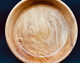 Small shallow homemade bowl from cherry wood