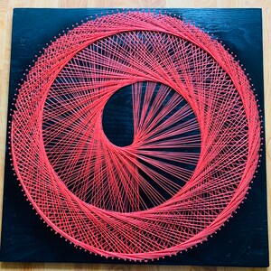 Homemade string art - bright salmon colored mandala
