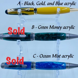 Handmade turned comfort twist pens – Gold, black and blue acrylic, Green Money acrylic, and Ocean Mist acrylic