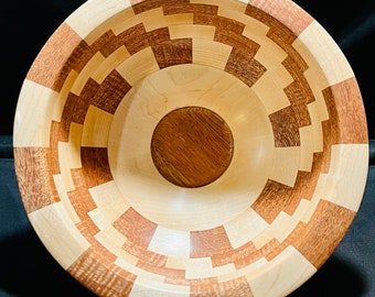 Segmented bowl made with maple and mahogany with a mahogany base and cork bottom.