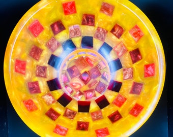 Homemade resin handturned yellow and orange bowl with red checkboard pattern.