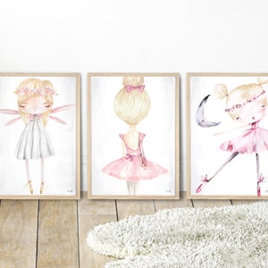May include: Three framed watercolor illustrations of ballerinas. The first ballerina is wearing a white dress and has wings. The second ballerina is wearing a pink dress and has her hair in a bun. The third ballerina is wearing a pink dress and is dancing with a crescent moon.
