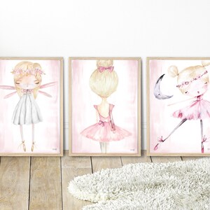 May include: Three framed watercolor illustrations of ballerinas. The first ballerina is wearing a white dress and has wings. The second ballerina is wearing a pink tutu and has her hair in a bun. The third ballerina is wearing a pink tutu and is dancing with a crescent moon.