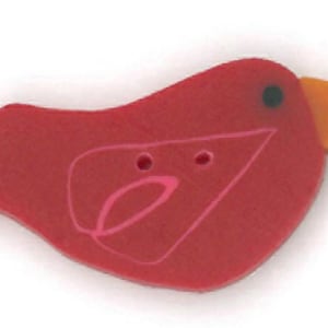 May include: A red bird-shaped button with a pink design and two holes for sewing. The beak is orange.