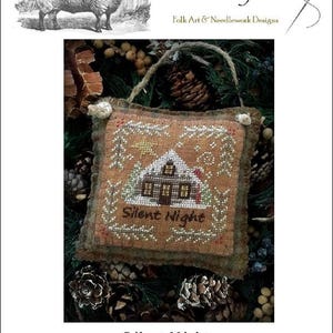 May include: A cross-stitch design featuring a winter scene with a house and the words "Silent Night." The design is framed with a floral border and has a burlap-like texture. The image includes the text "The Woolly Ewe" and a drawing of a sheep.