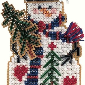 May include: A handmade snowman ornament with a beaded design. The snowman wears a blue hat, a striped scarf, and holds a beaded Christmas tree. The ornament has a white background with red heart accents and a snowflake.