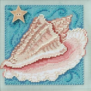May include: Needlepoint design featuring a seashell in shades of pink and white, set against a blue background with a wave pattern. A tan star-shaped button is in the upper left corner. The design is on a square canvas.