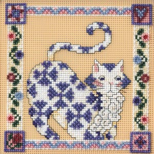 May include: Needlepoint cat design with a white body and blue diamond pattern. The cat is set against a tan background, framed by a floral border with pink, blue, and purple accents. The corners feature square designs.