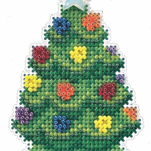 May include: A handmade Christmas tree ornament with a green cross-stitch design. The tree is decorated with colorful bead ornaments in red, yellow, blue, orange, and purple. A light blue star tops the tree. The ornament has a scalloped edge.