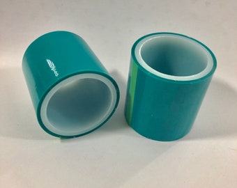 May include: Two rolls of teal colored tape with white inner cores. The tape is rolled up and ready to be used.