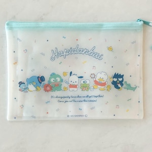 May include: A clear plastic zippered pouch with a white background and colorful cartoon characters. The pouch features the text "Hapidanbui" and the phrase "It's alwaysparty time when we all get together! Come join us! The more the merrier!"  The pouch also includes the copyright symbol and the text "23 SANRIO".