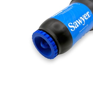 May include: A black and blue Sawyer water filter. The filter has a blue cap and a blue label with the brand name "Sawyer" in white. The filter is designed for outdoor use and water purification.
