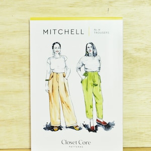 May include: A sewing pattern for trousers called "Mitchell" by Closet Core Patterns. The pattern shows two women wearing different versions of the trousers, one in a light yellow color and the other in a light green color.