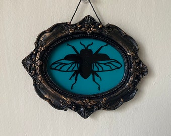 Small framed glass painted beetle