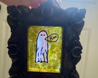 Small framed glass painted green ghost