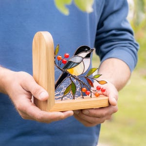 stained glass bird ornament as bookend decor.