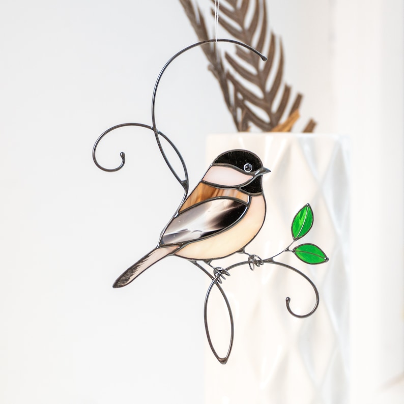 Beautiful bird gift on the wire branch with green leaf