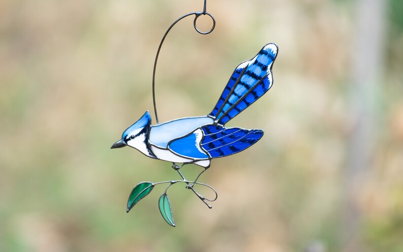 Stained Glass Blue Jay window hangings decorated with green stained glass leaves and copper decoration