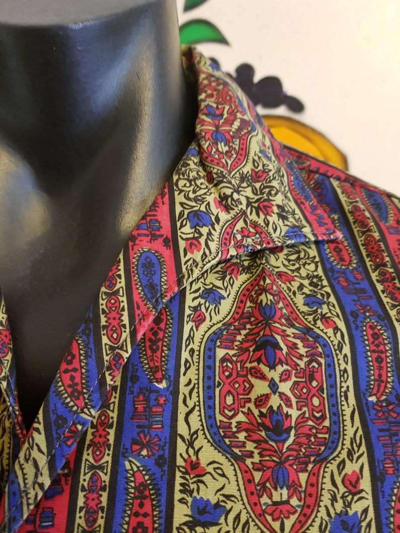 Very cool 1960s casual cotton shirt in olive green rasberry and bright blue paisley .