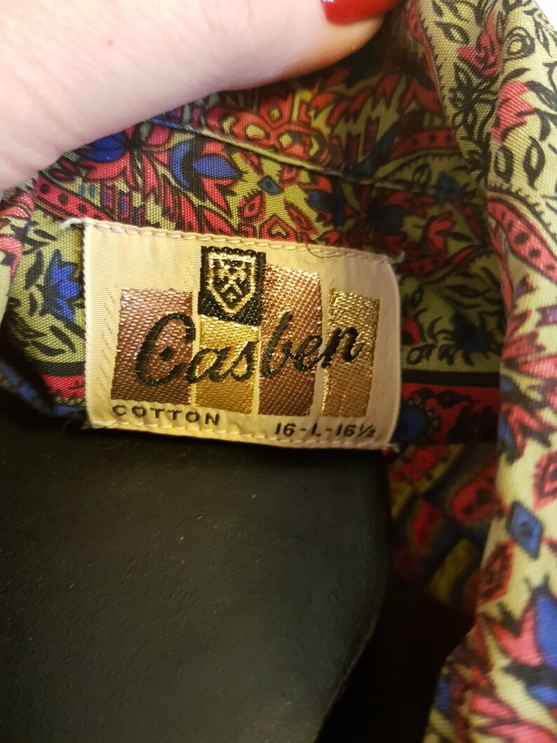 Very cool 1960s casual cotton shirt in olive green rasberry and bright blue paisley .