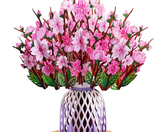 May include: A 3D pop-up card featuring a bouquet of pink cherry blossoms in a purple and white vase. The vase has a lattice design and sits on a yellow and orange base.