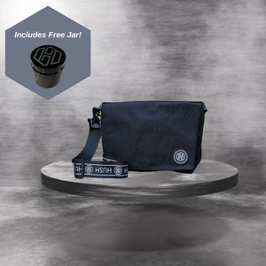 May include: Black messenger bag with a white logo and a black and white adjustable strap with the word "HUSH" printed on it. Includes Free Jar!