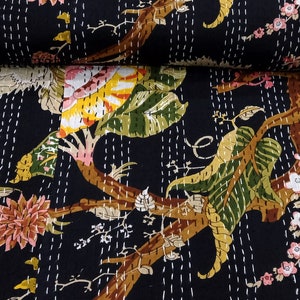 May include: Black kantha quilt with a floral pattern featuring white stitching. The quilt has a dark background with a variety of flowers and leaves in shades of pink, yellow, green, and brown.