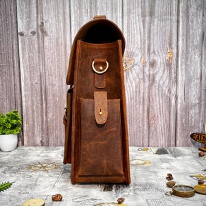 Side profile of the leather messenger bag showcasing its structure and depth