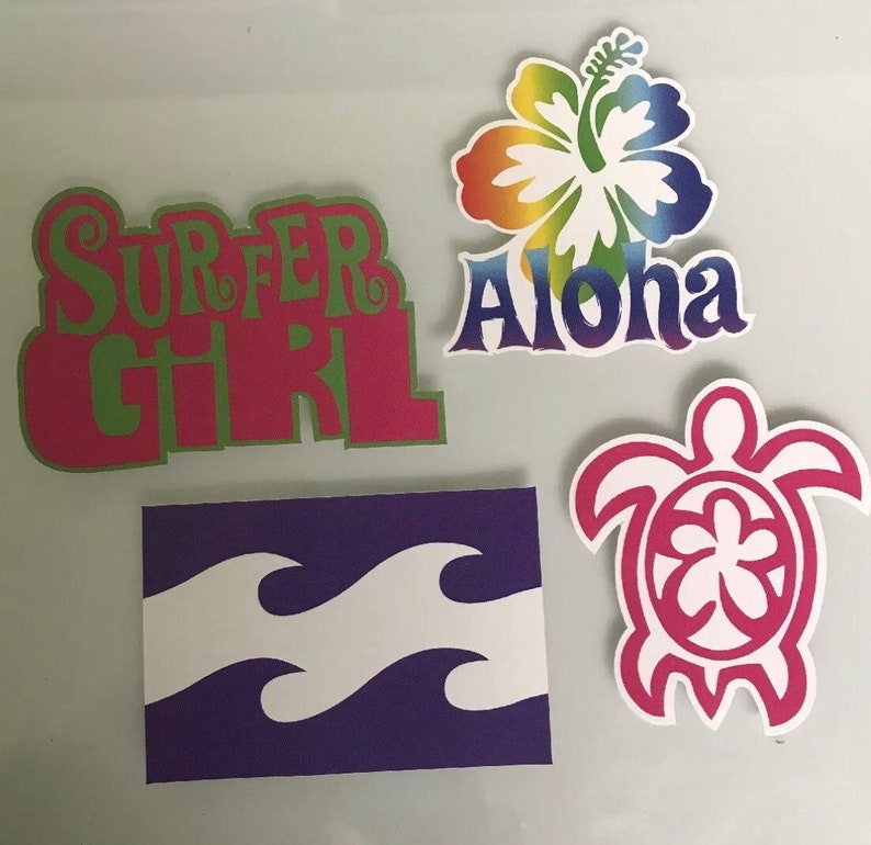 May include: Four colorful stickers with a Hawaiian theme. The stickers feature a rainbow hibiscus flower with the word "Aloha", a pink turtle with a flower in its shell, a purple and white wave design, and a pink and green "Surfer Girl" design.