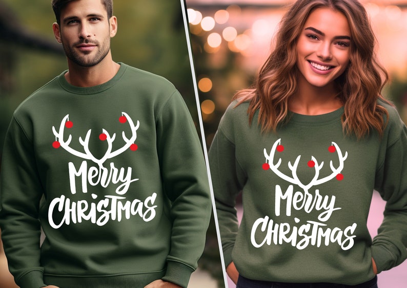 May include: Green sweatshirt with a white antler design and the words "Merry Christmas" in white. The antlers have red ball accents. The sweatshirt is a crew neck style.