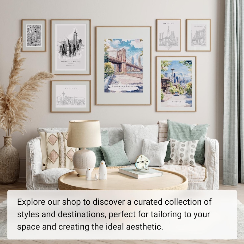 May include: A collection of framed art prints featuring cityscapes, including the Empire State Building, Brooklyn Bridge, and Seattle. The prints are displayed above a sofa with decorative pillows and a round coffee table. The overall aesthetic is modern and stylish.