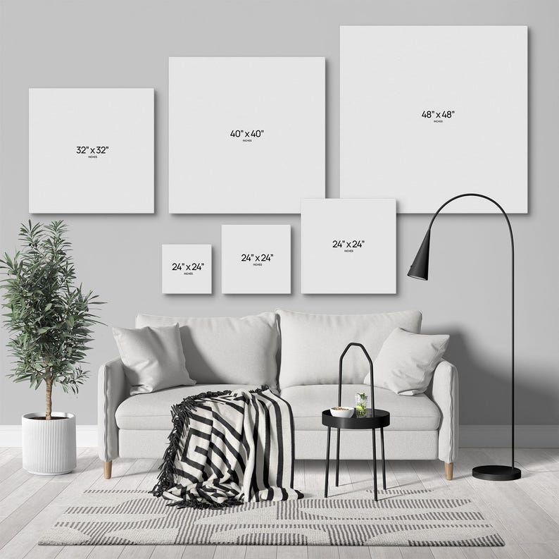a modern living room with a gray sofa, a black and white striped blanket, and a black floor lamp. Above the sofa, there are five white square frames with black text indicating the size of the frames, ranging from 48 inches to 48 inches.