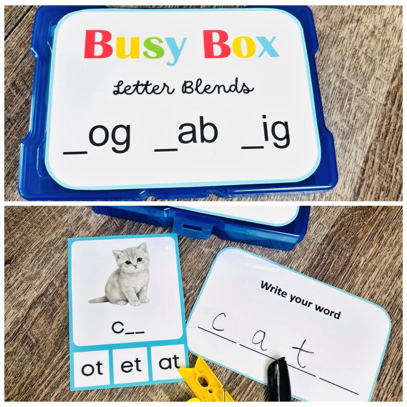 Puede incluir: Una Busy Box azul de pl&aacute;stico con combinaciones de letras, incluyendo "_og", "_ab" e "_ig". La caja contiene tarjetas con una imagen de gatito y la palabra "cat", junto con letras. Tambi&eacute;n se ve un clip amarillo.