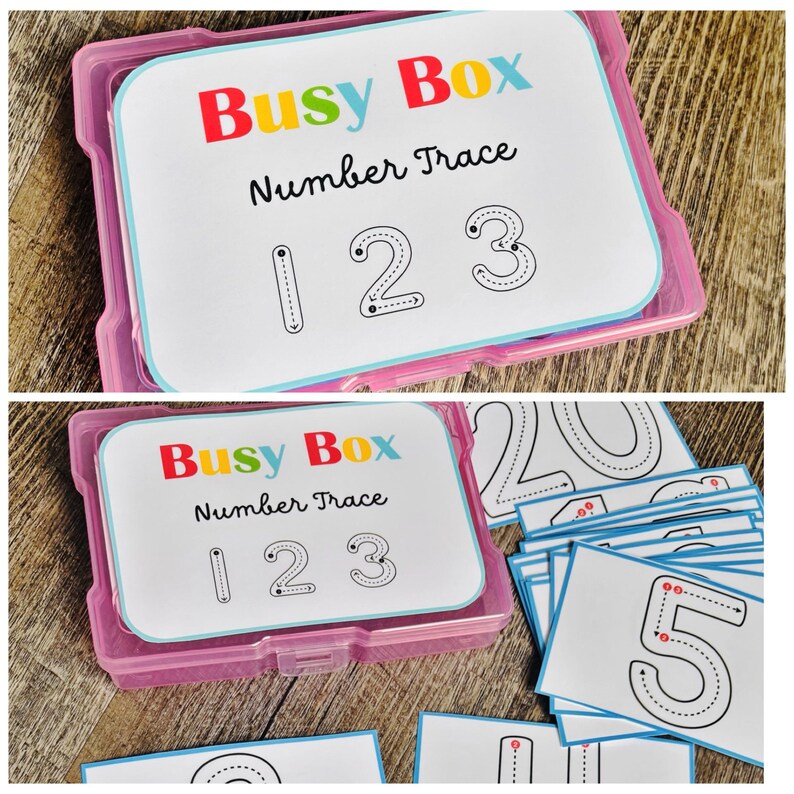 Puede incluir: Una caja de pl&aacute;stico rosa que contiene tarjetas para trazar n&uacute;meros. Las tarjetas tienen el texto "Busy Box Number Trace" y los n&uacute;meros 1, 2 y 3. Tambi&eacute;n se ven otras tarjetas con n&uacute;meros.