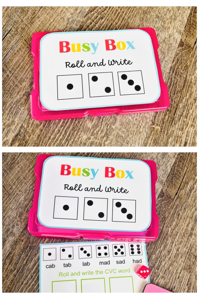 Puede incluir: Un juego educativo rosa y blanco llamado "Busy Box" con el texto "Roll and write". El juego incluye tarjetas con patrones de dados y un dado rojo. La tarjeta inferior muestra palabras CVC.