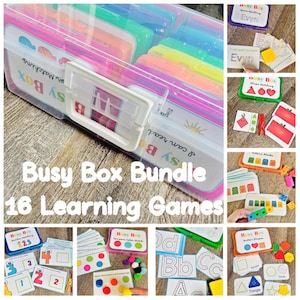 May include: A clear plastic Busy Box bundle with 16 learning games. The box contains colorful compartments. The image includes various learning games with shapes, numbers, letters, and matching activities. The text on the box reads "Busy Box Bundle 16 Learning Games."