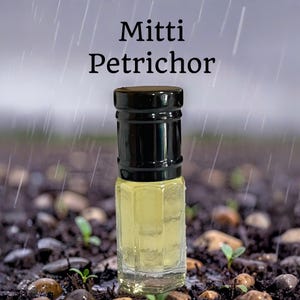May include: A small, clear glass bottle with a black cap, filled with a light yellow liquid. The bottle is labelled "Mitti Petrichor" and is set against a backdrop of soil, small stones, and sprouting plants, with a rain effect.