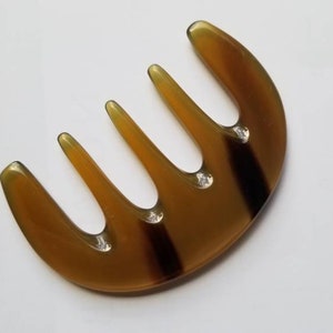 Polished translucent amber yak horn five-tooth comb, flat lay overhead showing natural color variation — Arakicrafts